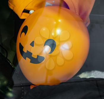 creepy orange balloon halloween decorations in the shape of a pumpkin with face