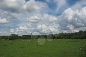 English countryside seen from a train to London, with selective focus on the horizon and motion blur on the foreground