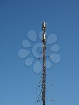 cellular antenna tower and electronic radio transceiver equipment part of a cellular network over blue sky