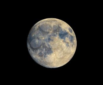 Full moon seen with an astronomical telescope, with enhanced colours to show the real colours of terrain surface