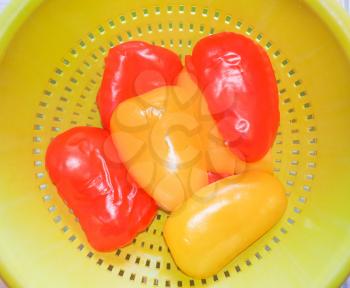 Green or red peppers vegetables healthy vegetarian food in a colander