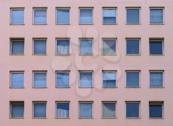 Modern pink facade with many square windows