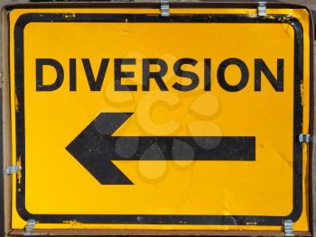Traffic sign for road diversion in black over yellow