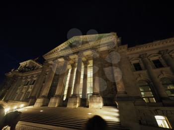 Bundestag German Houses of Parliament in Berlin, Germany at night. Dem deutschen Volke means To the German people