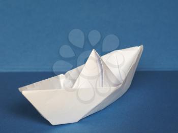toy paper boat over blue sea background