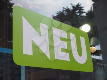 Neu (meaning New in German) sign in white over green