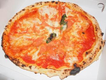 Italian Pizza Margherita (Margarita) with tomato and Mozzarella cheese in a cardboard box for take away