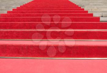 Red carpet on a stairway to mark the route of heads of state, vips and celebrities on ceremonial and formal occasions or events
