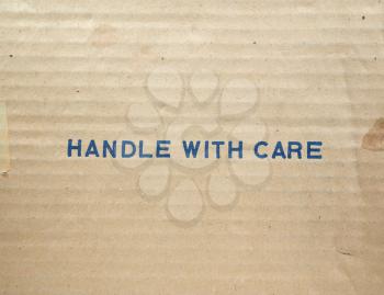 Handle with care tag on a corrugated cardboard packet
