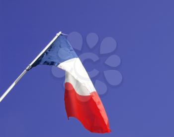 Flag of France over blue sky background