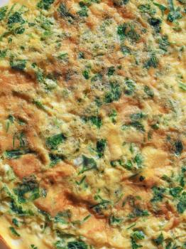 Omelette with beaten eggs fried with parsley and cilantro herbs useful as a background