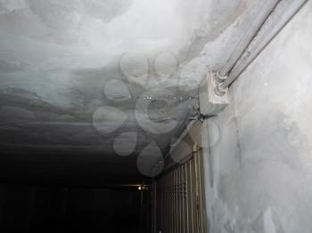 damage caused by dampness and moisture on a ceiling, with droplets of water infiltration