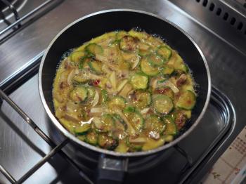 Courgettes and mushrooms omelette vegetarian food in a frying pad on gas cooker