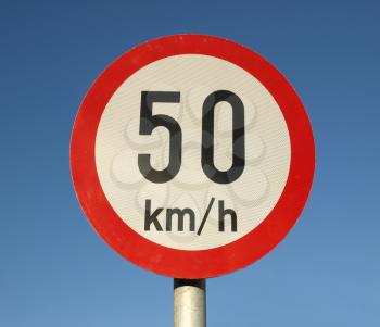 Traffic speed limit sign over blue sky