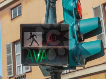 Traffic light for pedestrian crossing showing Avanti sign in green meaning Walk