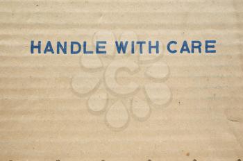 Handle with care tag on a corrugated cardboard packet