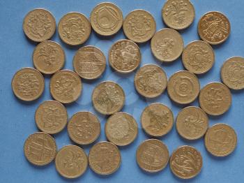 One Pound coins money (GBP), currency of United Kingdom over blue background