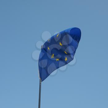 The national flag of European Union floating over blue sky