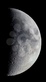 First quarter moon seen with an astronomical telescope, vertical