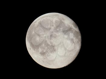 Full moon over dark black sky seen with a telescope from northern emisphere at night