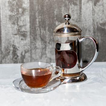 Tea glass and teapot, tea set on a silver background