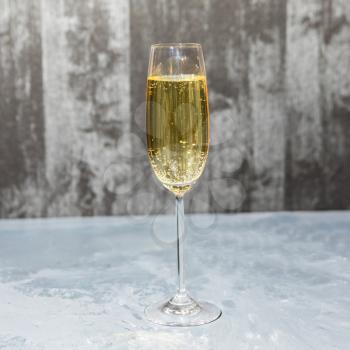 Glass of champagne isolated on a gray background