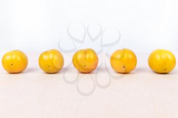 Yellow plum fruit on the white background isolated