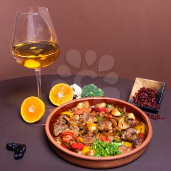 Tasty meat meal with white wine glass