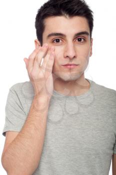 Royalty Free Photo of a Man Applying Eye Cream