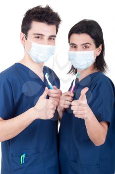Royalty Free Photo of Two Doctors Holding Toothbrushes