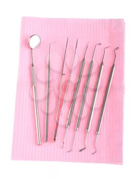 Royalty Free Photo of a Dentistry Kit on a Tray on a Pink Bib