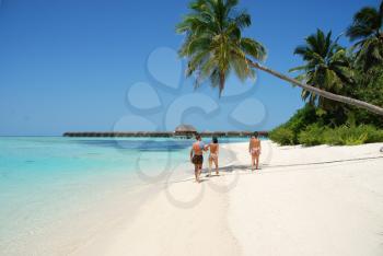 Royalty Free Photo of a Family Walking by the Beach in Maldives