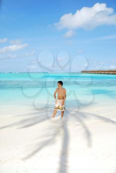 Royalty Free Photo of a Man Sunbathing at a Maldivian Resort