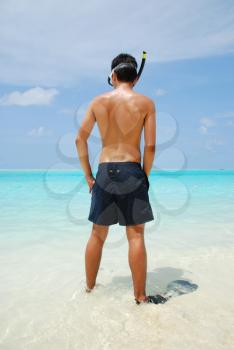 Royalty Free Photo of a Man Snorkeling on a Beach