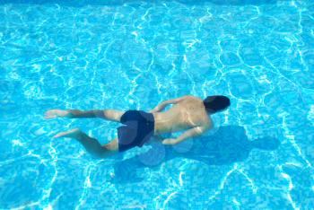 Royalty Free Photo of a Man Swimming in a Pool
