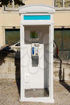 Royalty Free Photo of a White Telephone Booth in Lisbon, Portugal