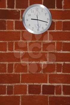 Royalty Free Photo of a Clock on a Brick Wall
