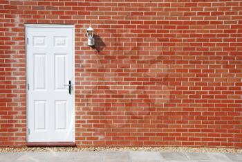 Royalty Free Photo of a White Door on a Brick Wall