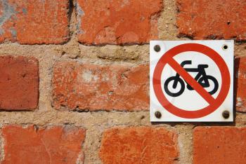Royalty Free Photo of a No Through Road Sign for Motorcycles on a Brick Wall