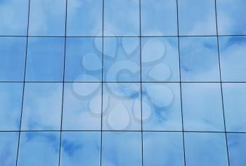 Royalty Free Photo of a Reflection of Clouds on a Building