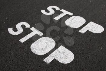 Royalty Free Photo of Stop Signs Painted on Pavement