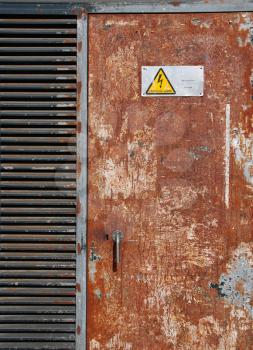 Royalty Free Photo of a Danger High Voltage Sign on a Rusty Metal Door
