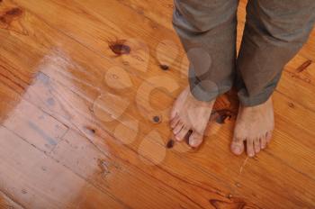 Royalty Free Photo of Bare Feet on a Wooden Floor