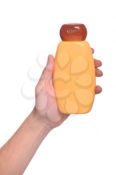 Royalty Free Photo of a Person Holding a Bottle of Sunscreen