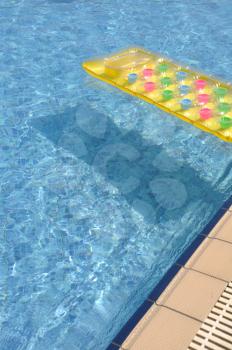 Royalty Free Photo of an Inflatable Mattress in a Pool