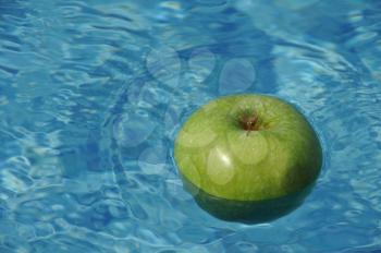 Royalty Free Photo of an Apple in a Swimming Pool