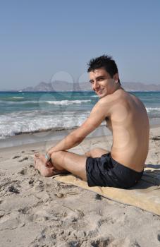Royalty Free Photo of a Man Relaxing on the Beach