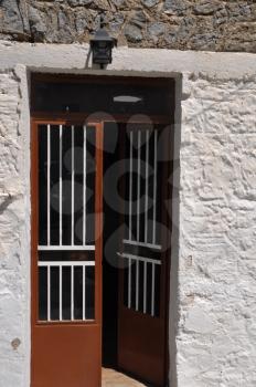 Royalty Free Photo of a Brown Greek Door in Lagoudi village (Kos), Greece