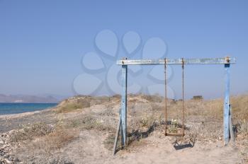 Royalty Free Photo of an Old Rusty Swing in Greece