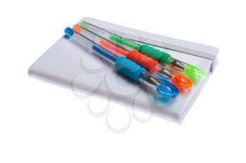 Royalty Free Photo of Pens on a Notebook